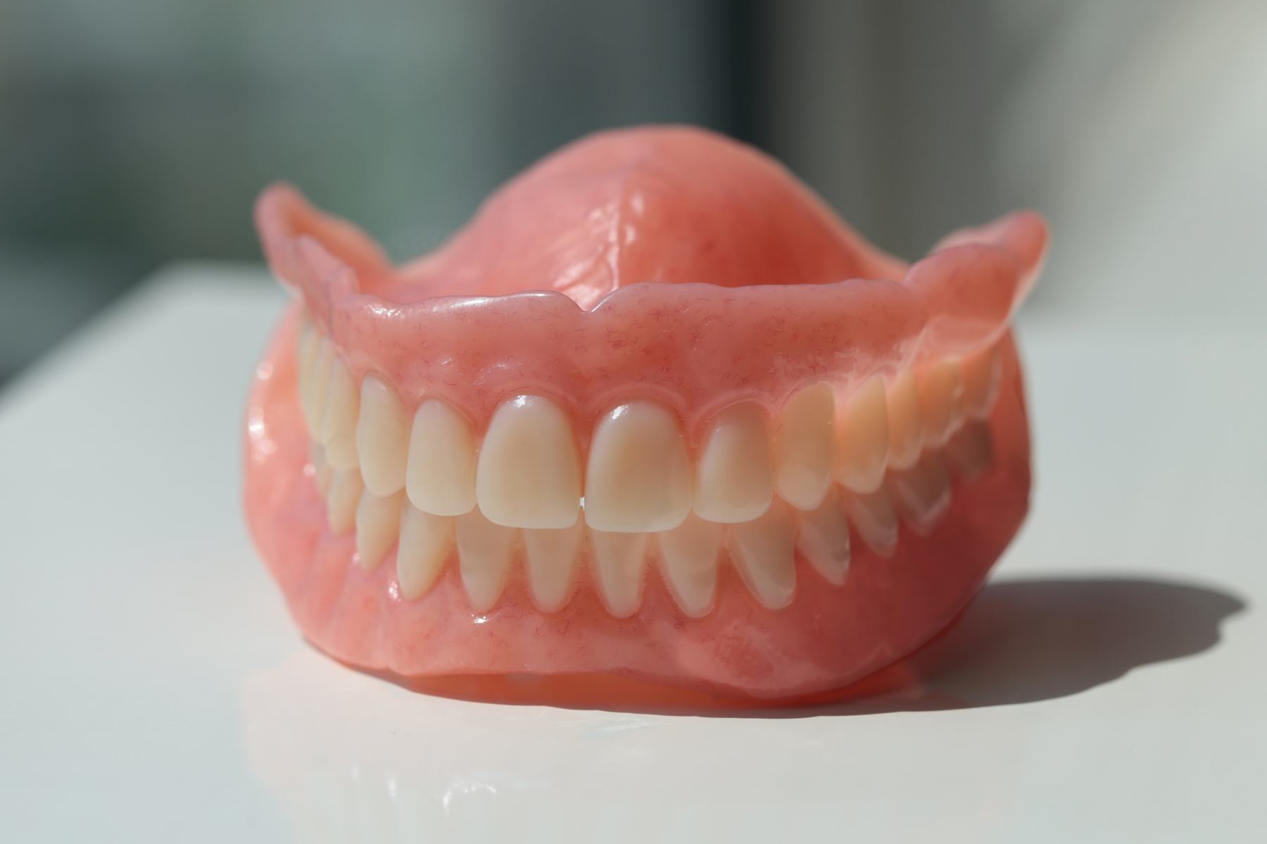 A complete denture on a light background