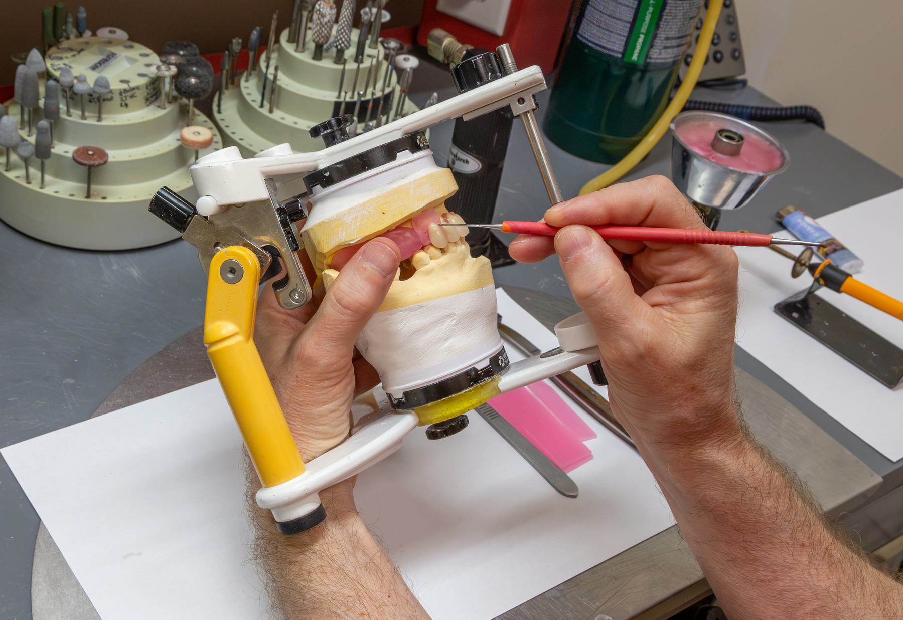 Hand-finishing a denture at the lab bench